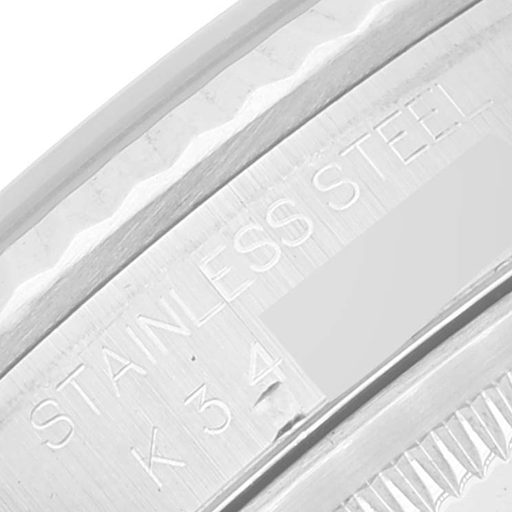 This image shows a close-up of the stainless steel bezel and part of the case of a Rolex Datejust 16234 Men's Stainless Steel Mother of Pearl Dial 16234 Men's Stainless Steel Mother of Pearl Dial watch.