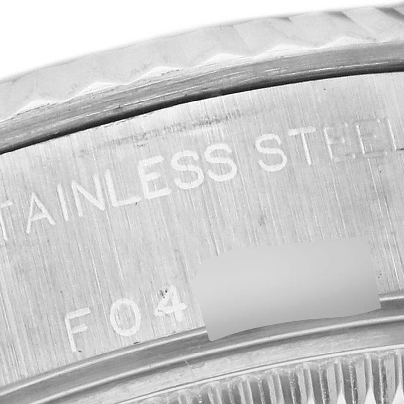 The image shows a close-up of the stainless steel case back with engravings on a Rolex Datejust 179174 Women
s Stainless Steel Mother of Pearl Dial 179174 Women
s Stainless Steel Mother of Pearl Dial watch.