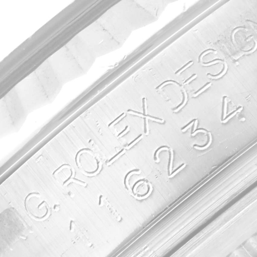 This is a close-up of the inner bezel of a Rolex Datejust 116234 Men's Stainless Steel Silver Dial 116234 Men's Stainless Steel Silver Dial watch showing engraved serial numbers and the brand name.
