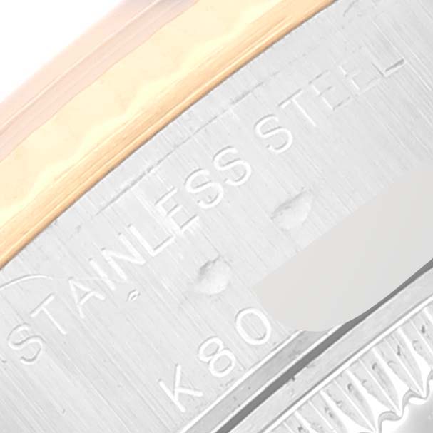 This close-up view of the Rolex Datejust 79173 Women's Steel and Gold (two tone) Blue Dial 79173 Women's Steel and Gold (two tone) Blue Dial shows part of the watch's stainless steel bezel and engraved serial number.