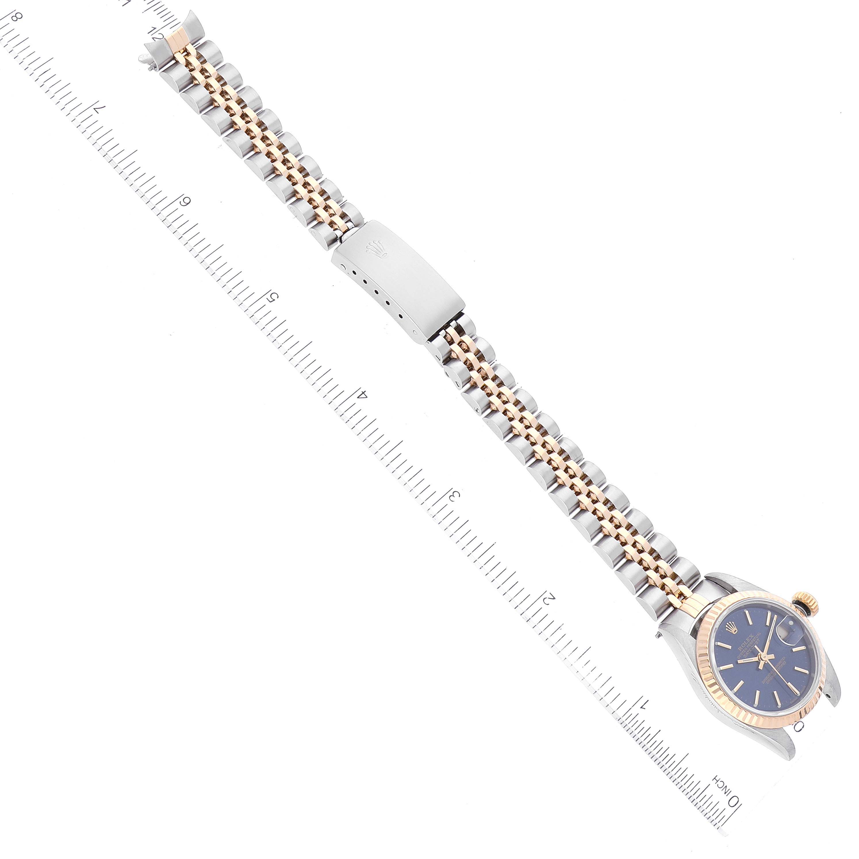 This image shows a Rolex Datejust 79173 Women's Steel and Gold (two tone) Blue Dial 79173 Women's Steel and Gold (two tone) Blue Dial watch from an overhead angle, focusing on the full bracelet and the watch face.  