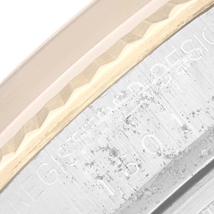 This is a close-up angle of the bezel and case side of the Rolex Datejust 1601 Men's Steel and Gold (two tone) Brown Dial 1601 Men's Steel and Gold (two tone) Brown Dial watch.