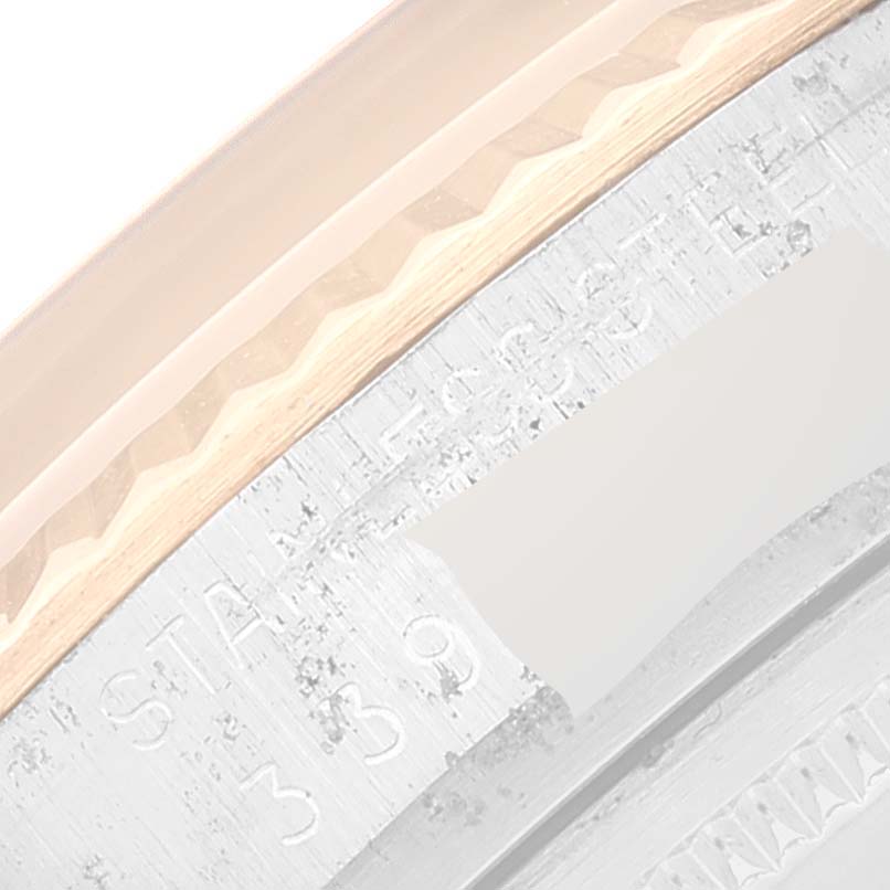 This close-up image of a Rolex Datejust 1601 Men's Steel and Gold (two tone) Brown Dial 1601 Men's Steel and Gold (two tone) Brown Dial watch shows part of the bezel and engraved details.