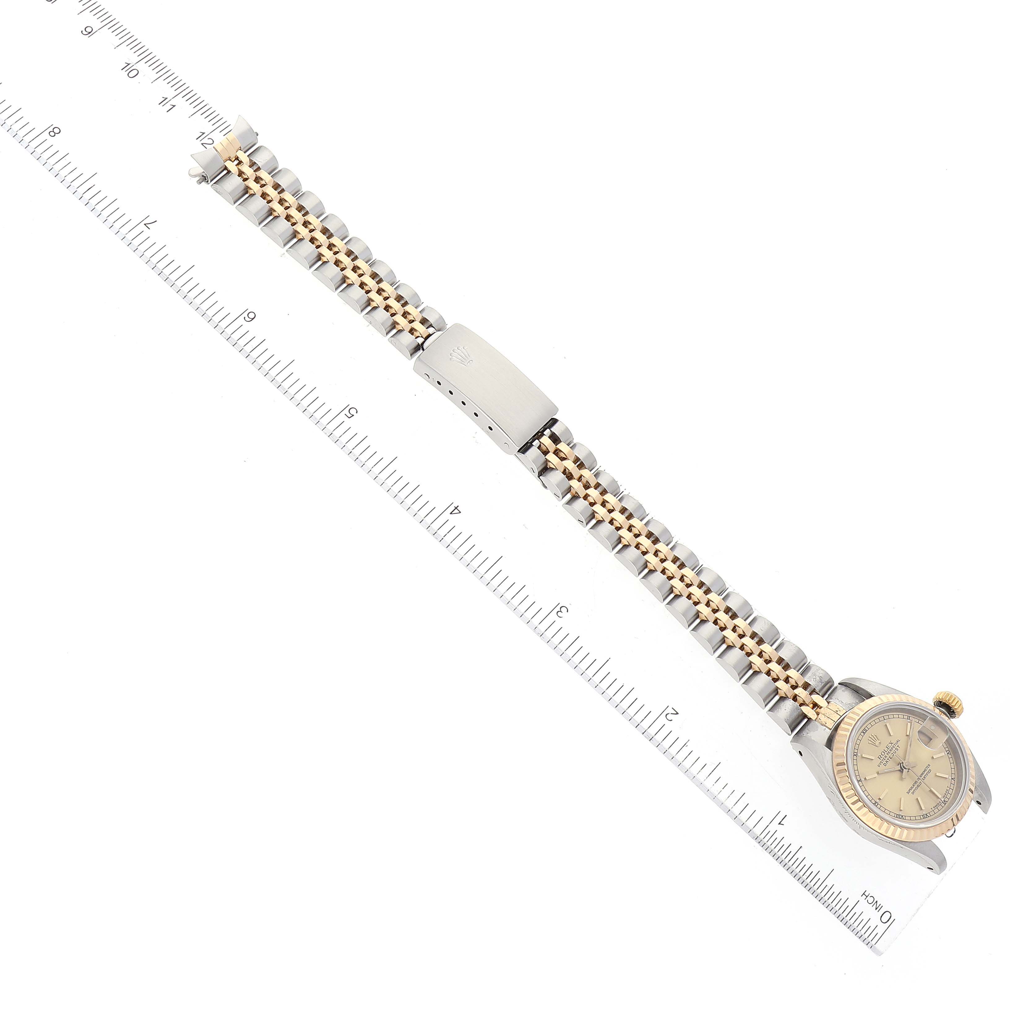 The image shows a Rolex Datejust 69173 Women's Steel and Gold (two tone) Champagne Dial 69173 Women's Steel and Gold (two tone) Champagne Dial watch laid flat with a ruler beside it, displaying the watch face, bracelet, and clasp.