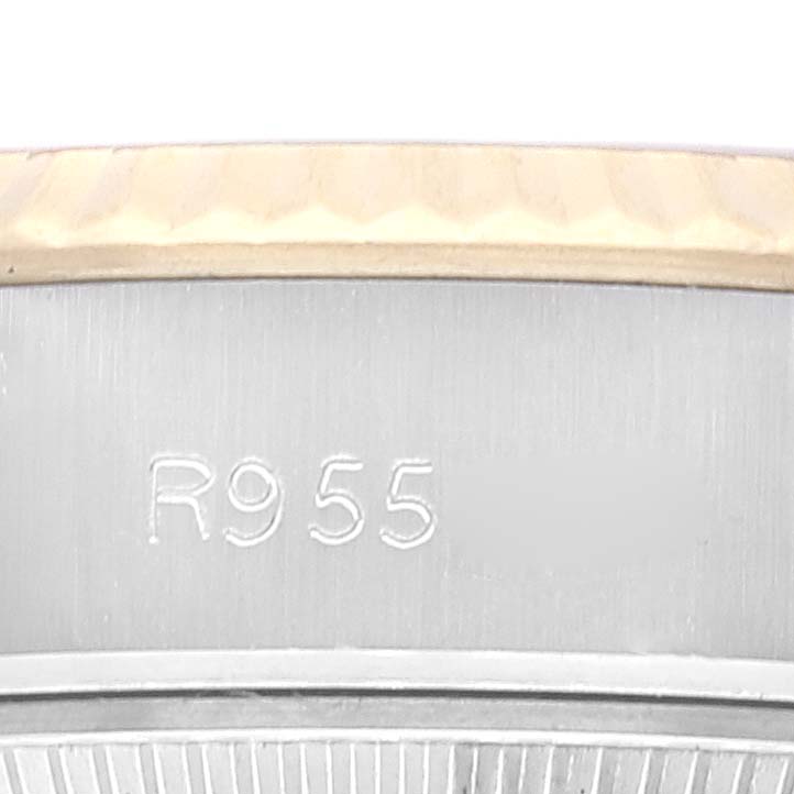 This close-up image shows the side of a Rolex Datejust 69173 Women's Steel and Gold (two tone) Champagne Dial 69173 Women's Steel and Gold (two tone) Champagne Dial watch with the engraving "R955."