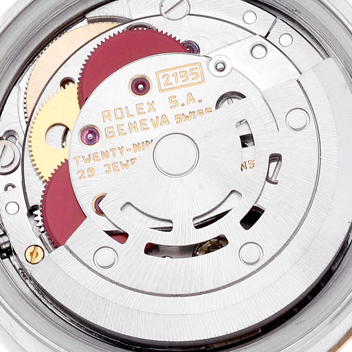 This is a close-up view of the internal mechanics of a Rolex Datejust 69173 Women's Steel and Gold (two tone) Champagne Dial 69173 Women's Steel and Gold (two tone) Champagne Dial watch, showcasing its movement parts and engraved details.