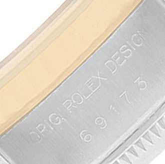 This image shows a close-up of the side of the Rolex Datejust 69173 Women
s Steel and Gold (two tone) Grey Dial 69173 Women
s Steel and Gold (two tone) Grey Dial watch case, highlighting the engraved text "ORIG. ROLEX DESIGN 69173".