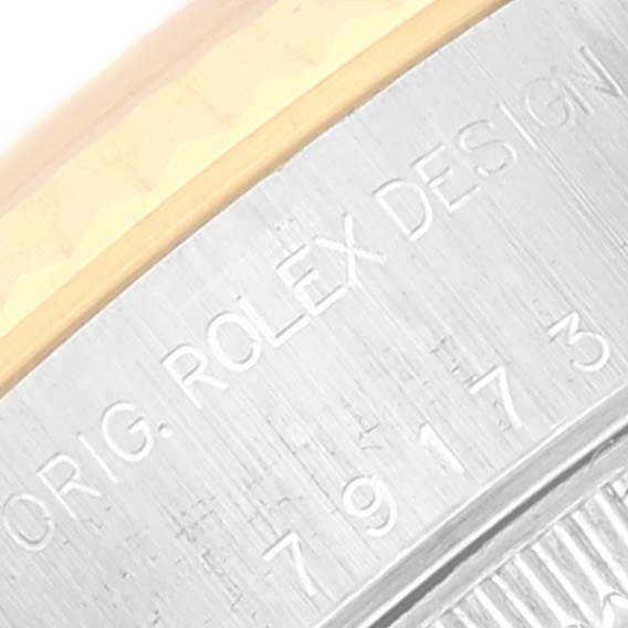 This is a close-up of the engraved casing on a Rolex Datejust 79173 Women's Steel and Gold (two tone) Blue Dial 79173 Women's Steel and Gold (two tone) Blue Dial watch.