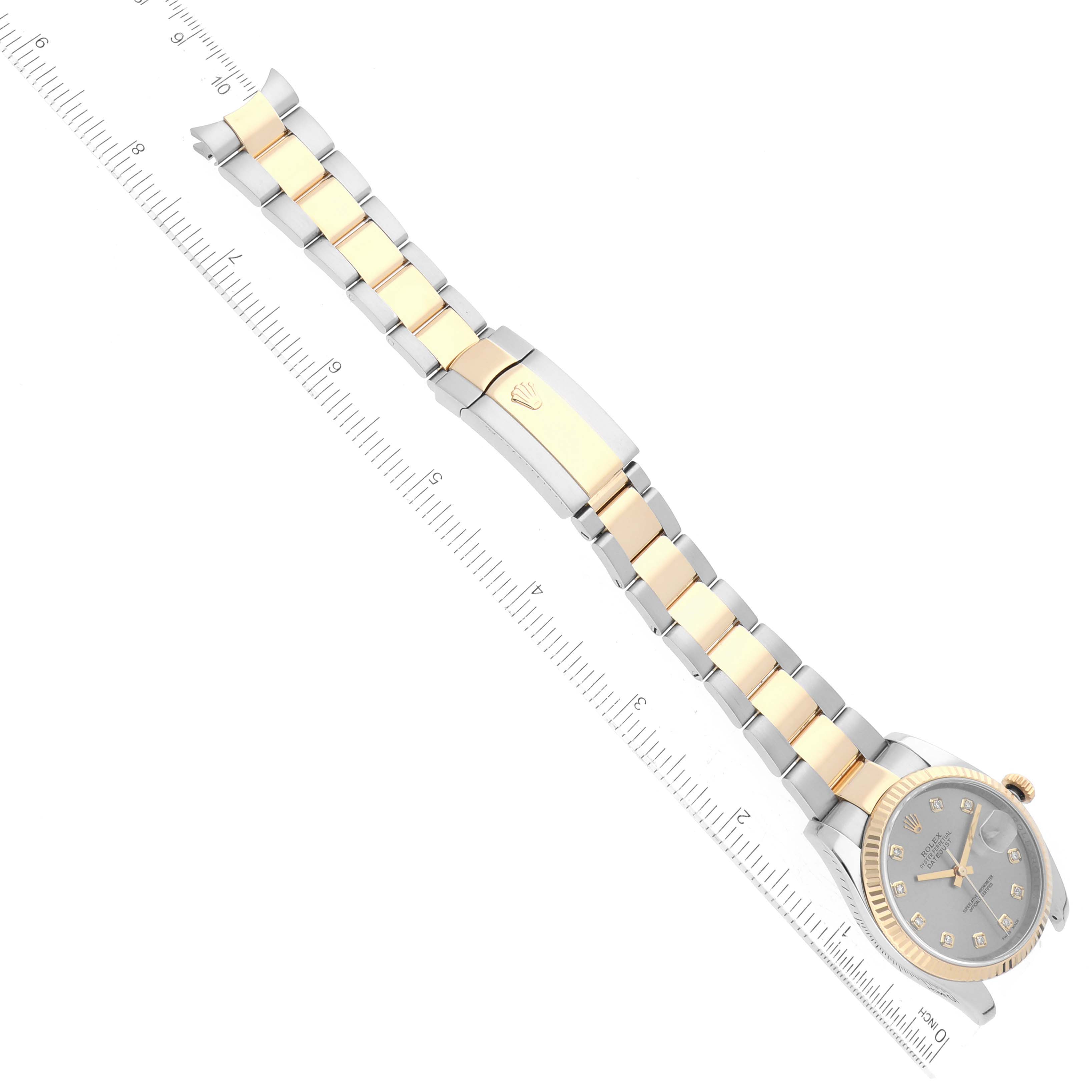 The image shows an overhead view of a Rolex Datejust 116233 Men's Steel and Gold (two tone) Silver Dial 116233 Men's Steel and Gold (two tone) Silver Dial watch, featuring its two-tone bracelet, clasp, and face.