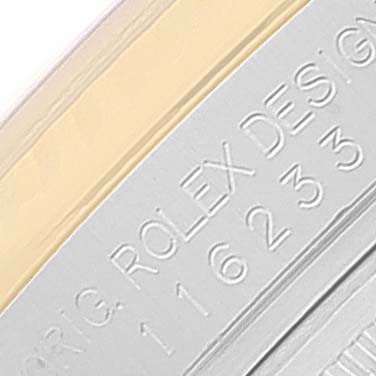 This close-up image shows the engraved bezel of a Rolex Datejust 116233 Men's Steel and Gold (two tone) Silver Dial 116233 Men's Steel and Gold (two tone) Silver Dial watch.