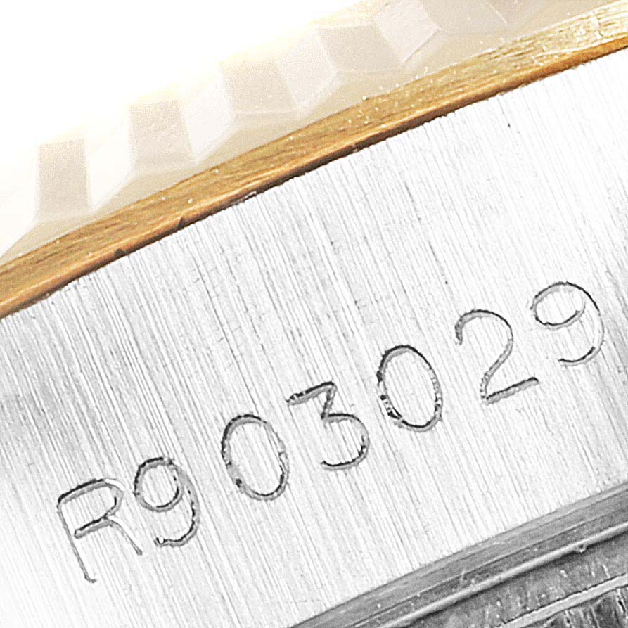 The image shows a close-up of the serial number engraved on the side of a Rolex Datejust 69173 Women
s Steel and Gold (two tone) Silver Dial 69173 Women
s Steel and Gold (two tone) Silver Dial watch case.
