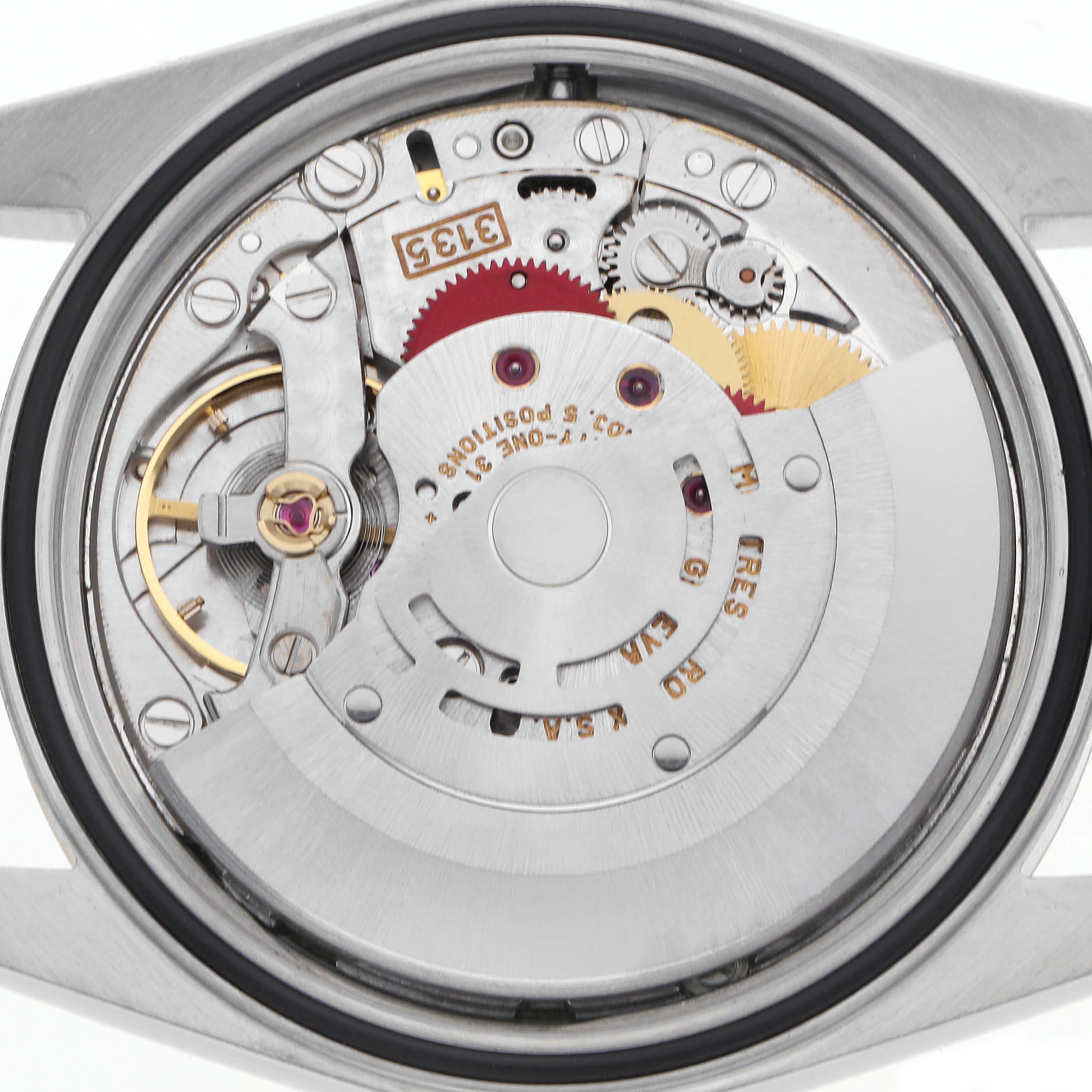 The image shows the movement of a Rolex Datejust 16233 Men's Steel and Gold (two tone) Silver Dial 16233 Men's Steel and Gold (two tone) Silver Dial watch, highlighting the gears and rotor from a top view.