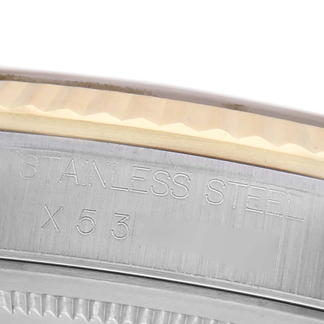 The image shows a close-up of the case edge and bezel of a Rolex Datejust 16233 Men's Steel and Gold (two tone) Silver Dial 16233 Men's Steel and Gold (two tone) Silver Dial, highlighting the "STAINLESS STEEL" engraving.