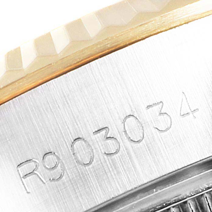 This image shows the side view of the Rolex Datejust 69173 Women
s Steel and Gold (two tone) White Dial 69173 Women
s Steel and Gold (two tone) White Dial watch, highlighting the model
s engraved serial number and the edge of the bezel.