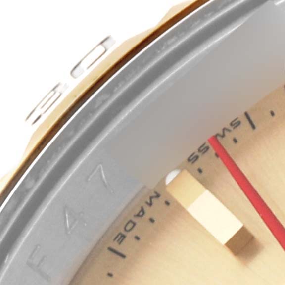 The image shows a close-up of the bezel, part of the dial, and the Swiss-made marking on a Rolex Turn-o-Graph 116263 Men's Steel and Gold (two tone) Champagne Dial 116263 Men's Steel and Gold (two tone) Champagne Dial watch.