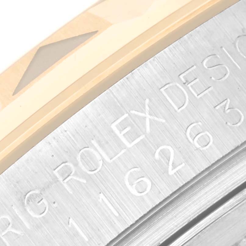 This close-up shows part of the bezel and the engraved side of the Rolex Turn-o-Graph 116263 Men's Steel and Gold (two tone) Champagne Dial 116263 Men's Steel and Gold (two tone) Champagne Dial watch.