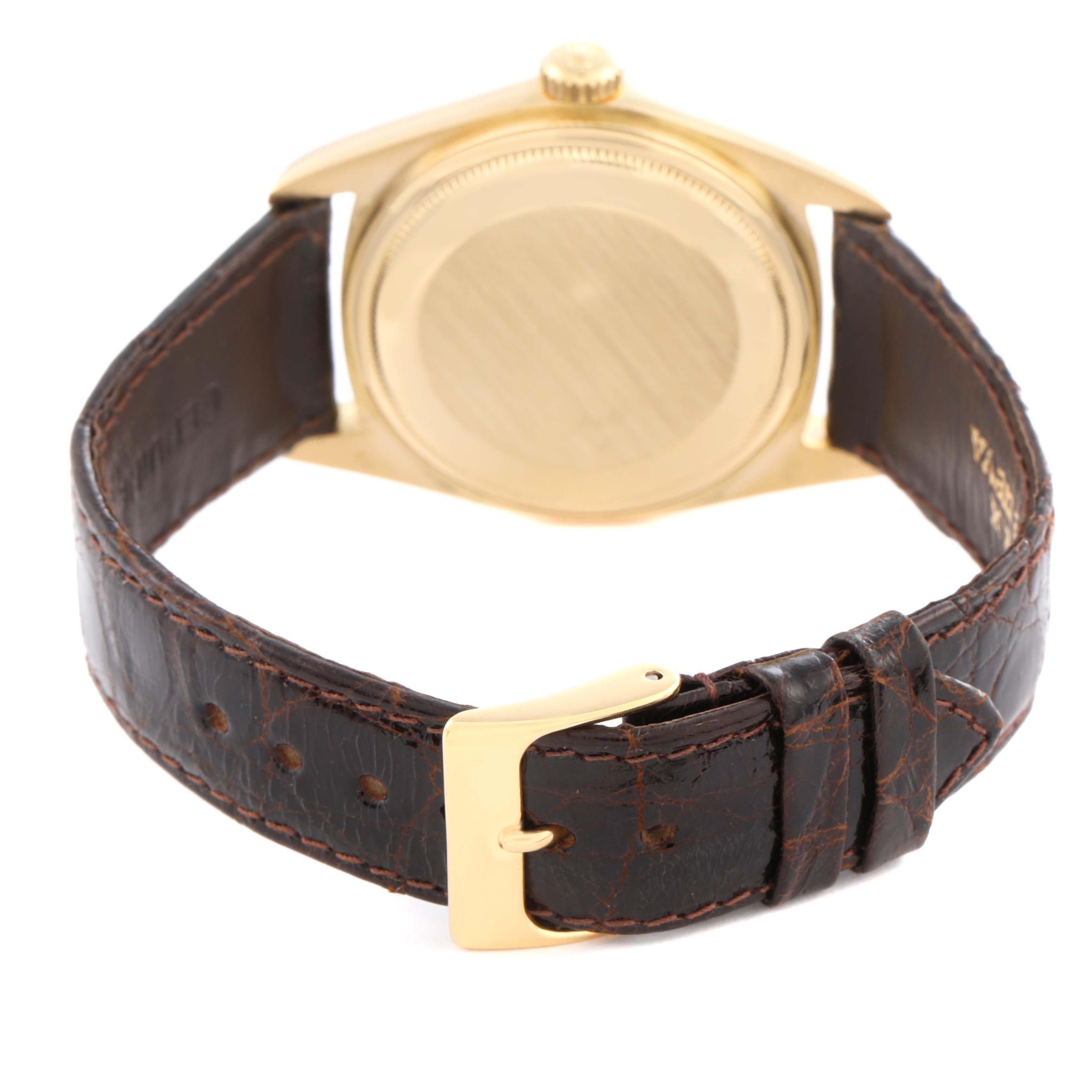 The image shows the back of the Rolex Vintage Collection 16018 Men's Yellow Gold Champagne Dial 16018 Men's Yellow Gold Champagne Dial watch, highlighting its gold case, brown leather strap, and clasp.