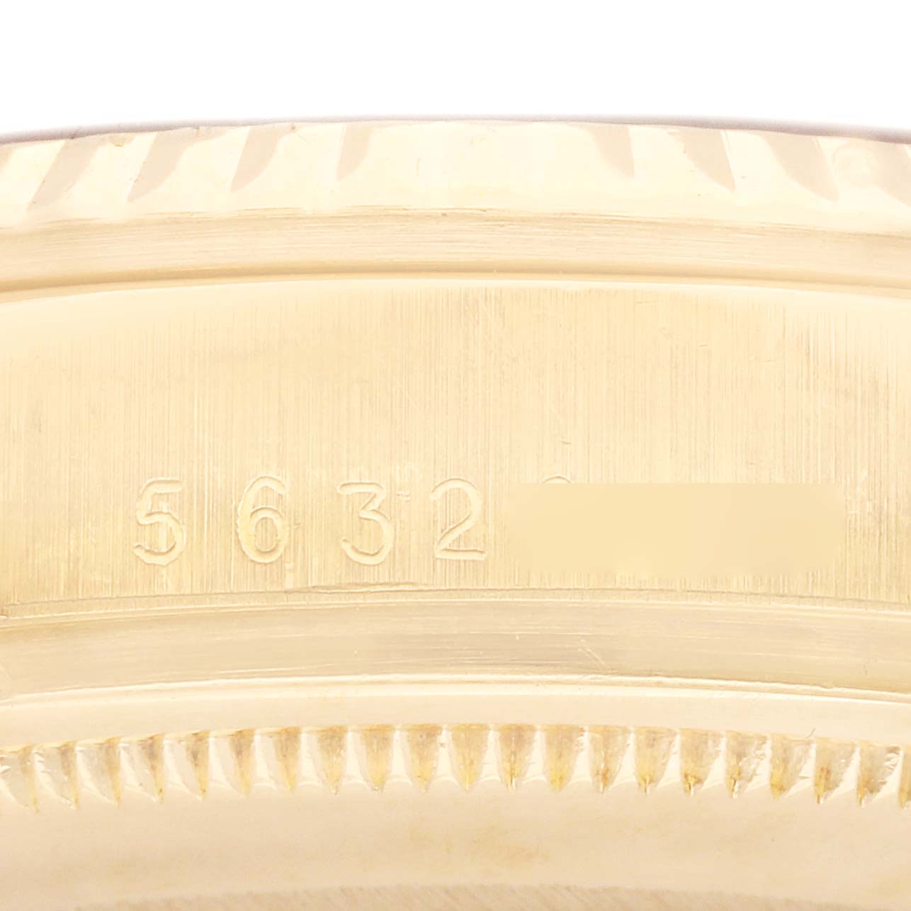 The image shows a close-up of the engraved serial number on the side of a Rolex Vintage Collection 16018 Men's Yellow Gold Champagne Dial 16018 Men's Yellow Gold Champagne Dial watch case.
