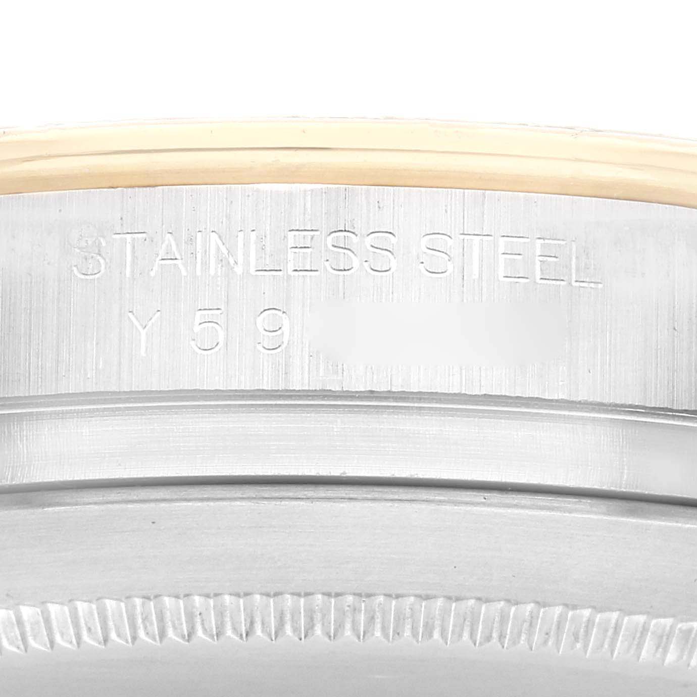 The image shows a close-up of the side engraving on a stainless steel Rolex Daytona 116523 Men's Steel and Gold (two tone) Silver Dial 116523 Men's Steel and Gold (two tone) Silver Dial watch case.