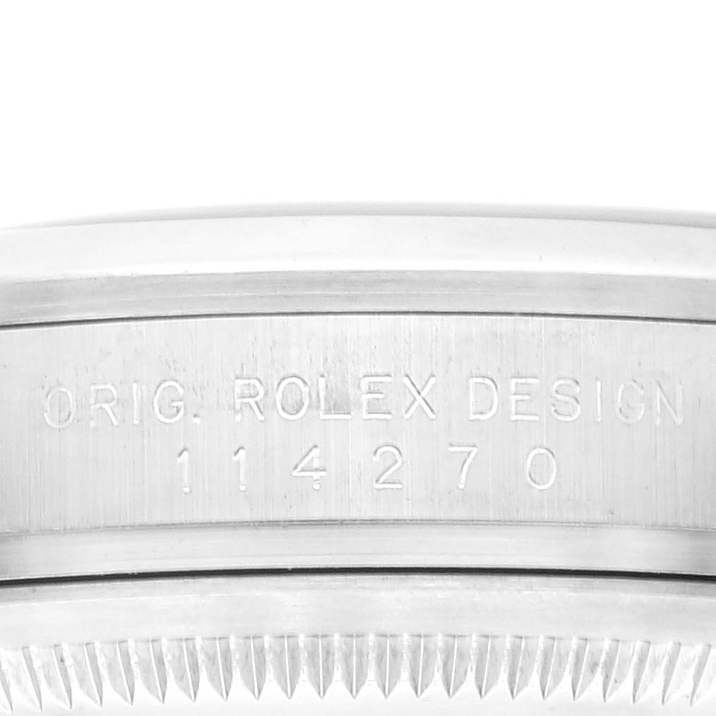 This image shows a close-up of the engraved side of a Rolex Explorer 114270 Men
s Stainless Steel Black Dial 114270 Men
s Stainless Steel Black Dial watch case with its design number.