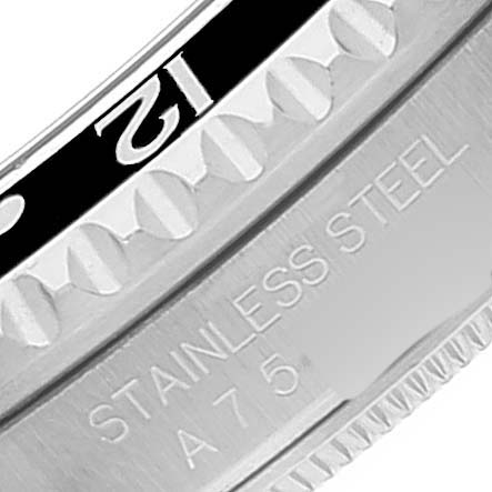 This is a close-up of the bezel and case edge of a Rolex GMT-Master 16700 Men's Stainless Steel Black Dial 16700 Men's Stainless Steel Black Dial showing the "12" marker and "Stainless Steel" engraving.