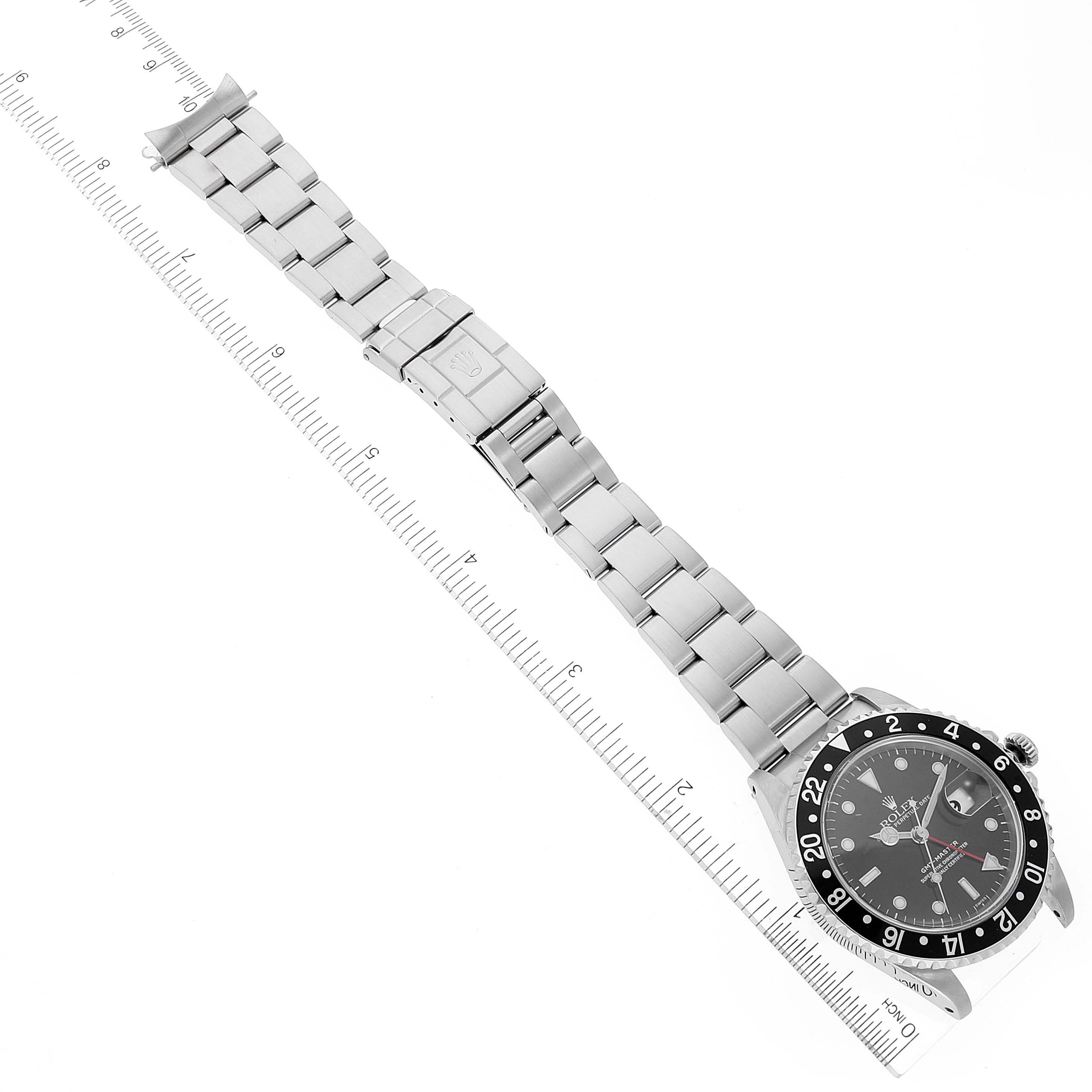 The Rolex GMT-Master 16700 Men's Stainless Steel Black Dial 16700 Men's Stainless Steel Black Dial watch is shown from a top-down angle, displaying the face, bezel, bracelet, and clasp.