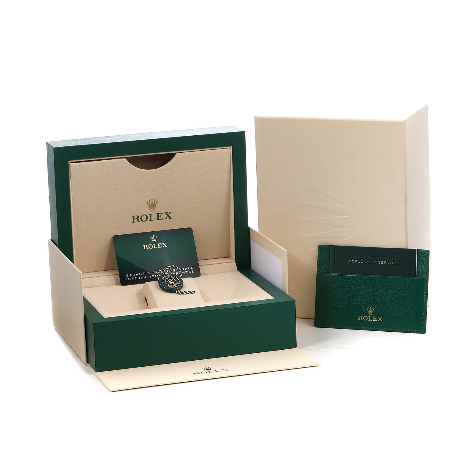 The Rolex Land‑Dweller 127334 Men's Stainless Steel White Dial watch is shown in its packaging, including the box, warranty card, and documentation.