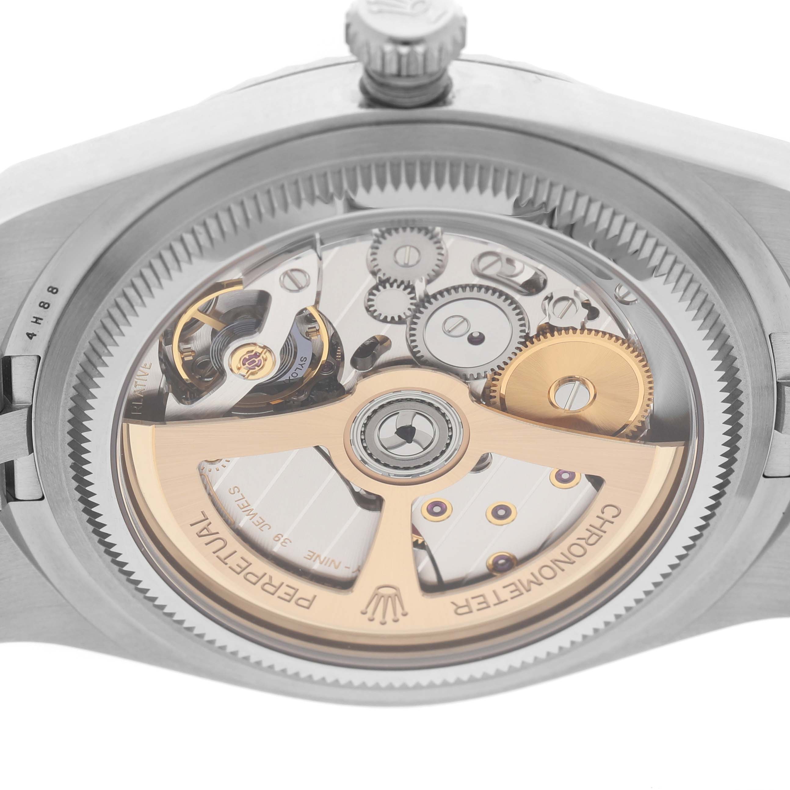 The image shows the back view of a Rolex Land-Dweller, highlighting its intricate movement and rotor design.