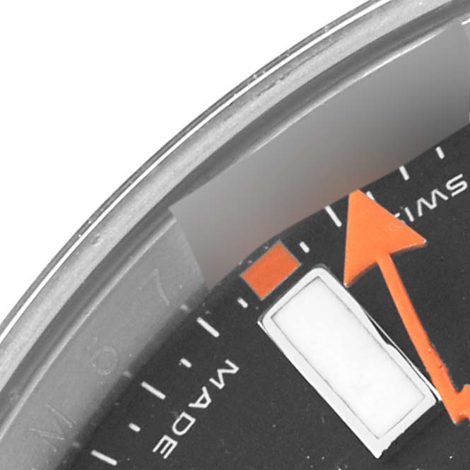 This close-up of the Rolex Milgauss 116400 Men's Stainless Steel Black Dial 116400 Men's Stainless Steel Black Dial watch shows part of the dial, hour markers, and the orange second hand.