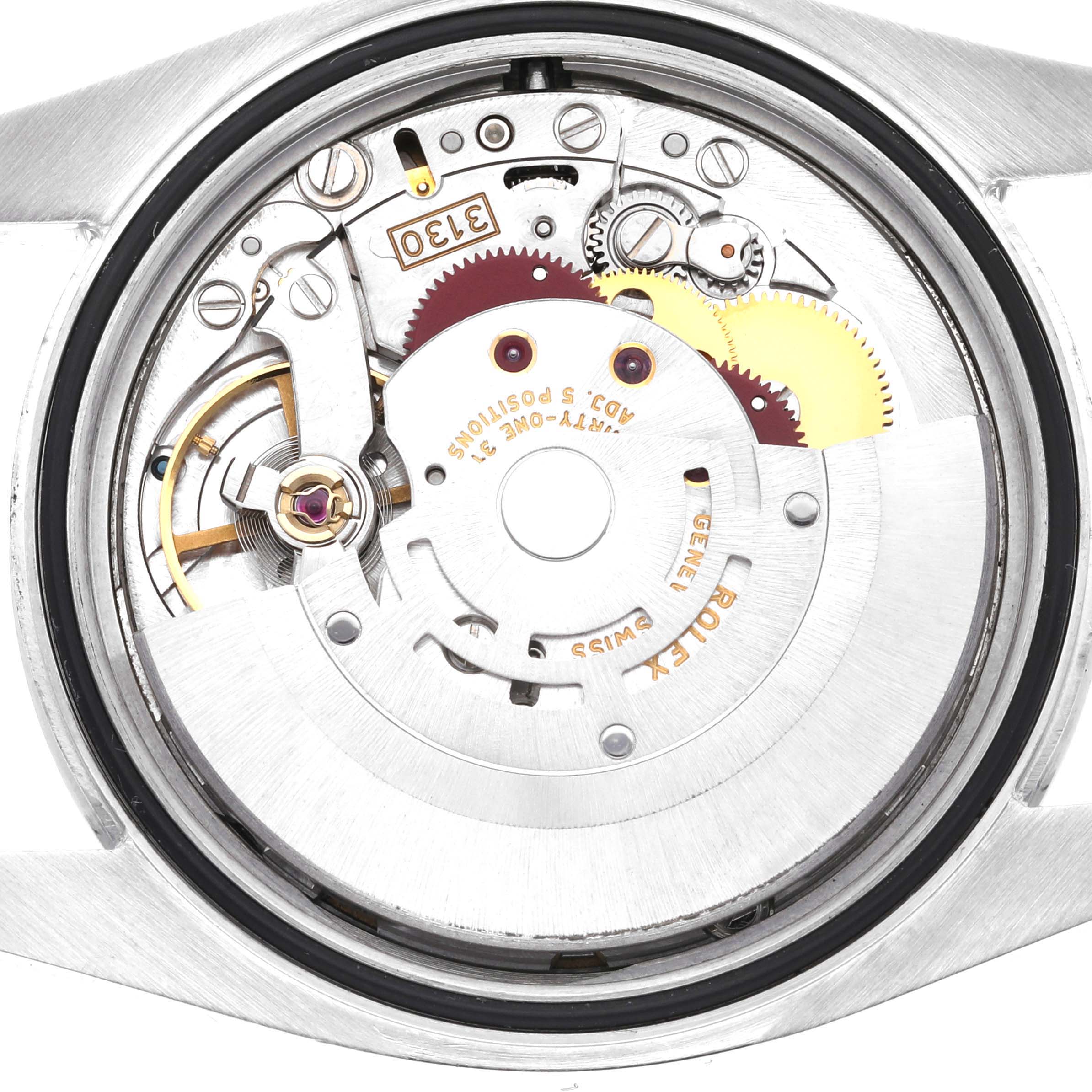 The image shows the inner mechanical movement of a Rolex Oyster Perpetual 116000 Men
s Stainless Steel Black Dial 116000 Men
s Stainless Steel Black Dial watch, viewed from the back with the case removed.