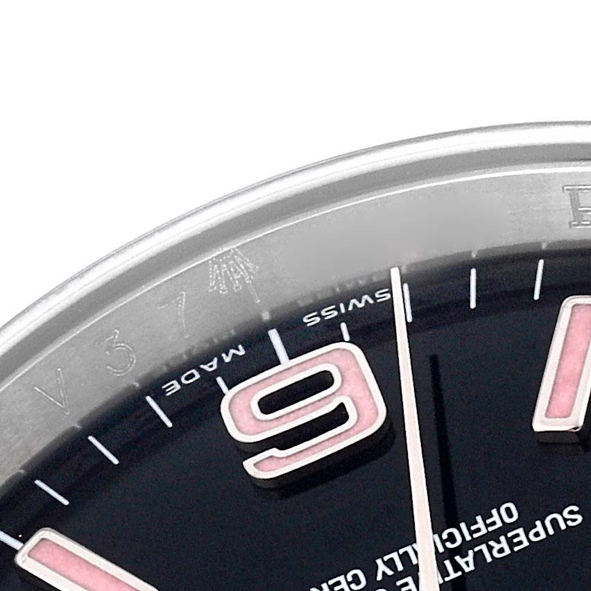 This image shows a partial close-up of the dial and bezel of a Rolex Oyster Perpetual 116000 Men
s Stainless Steel Black Dial 116000 Men
s Stainless Steel Black Dial watch, focusing on the 
9
 hour marker.