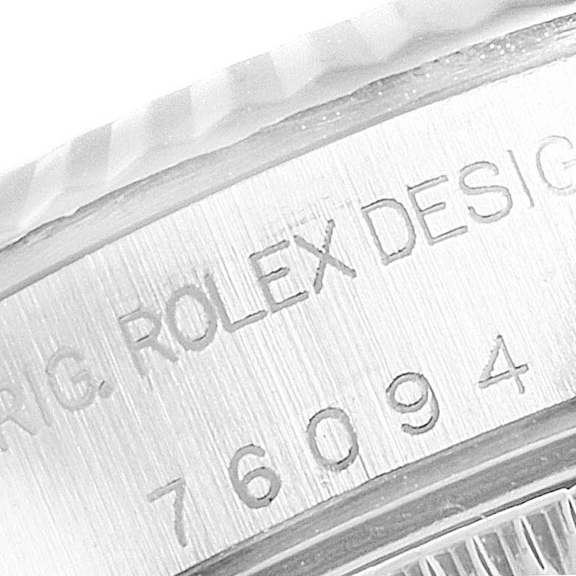The close-up image shows the engraved edge of the case for the Rolex Oyster Perpetual 76094 Women
s Stainless Steel White Dial 76094 Women
s Stainless Steel White Dial watch.