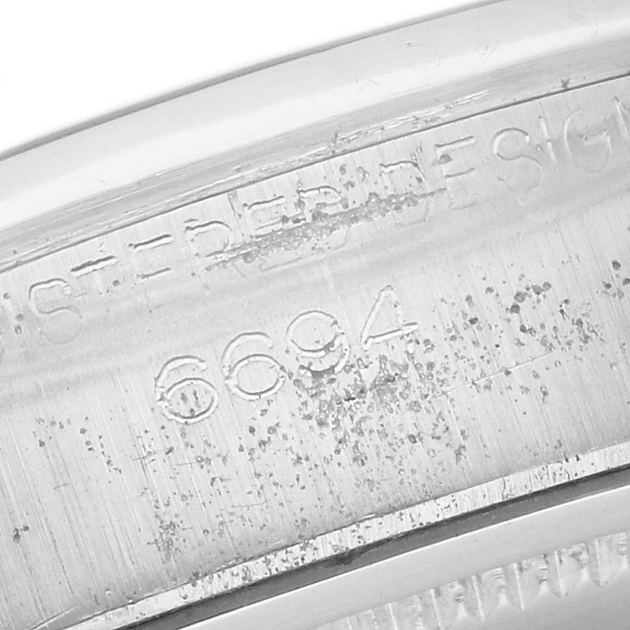 The image shows a close-up of the engraved case number on a Rolex Vintage Collection 6694 Men's Stainless Steel Silver Dial 6694 Men's Stainless Steel Silver Dial watch model.