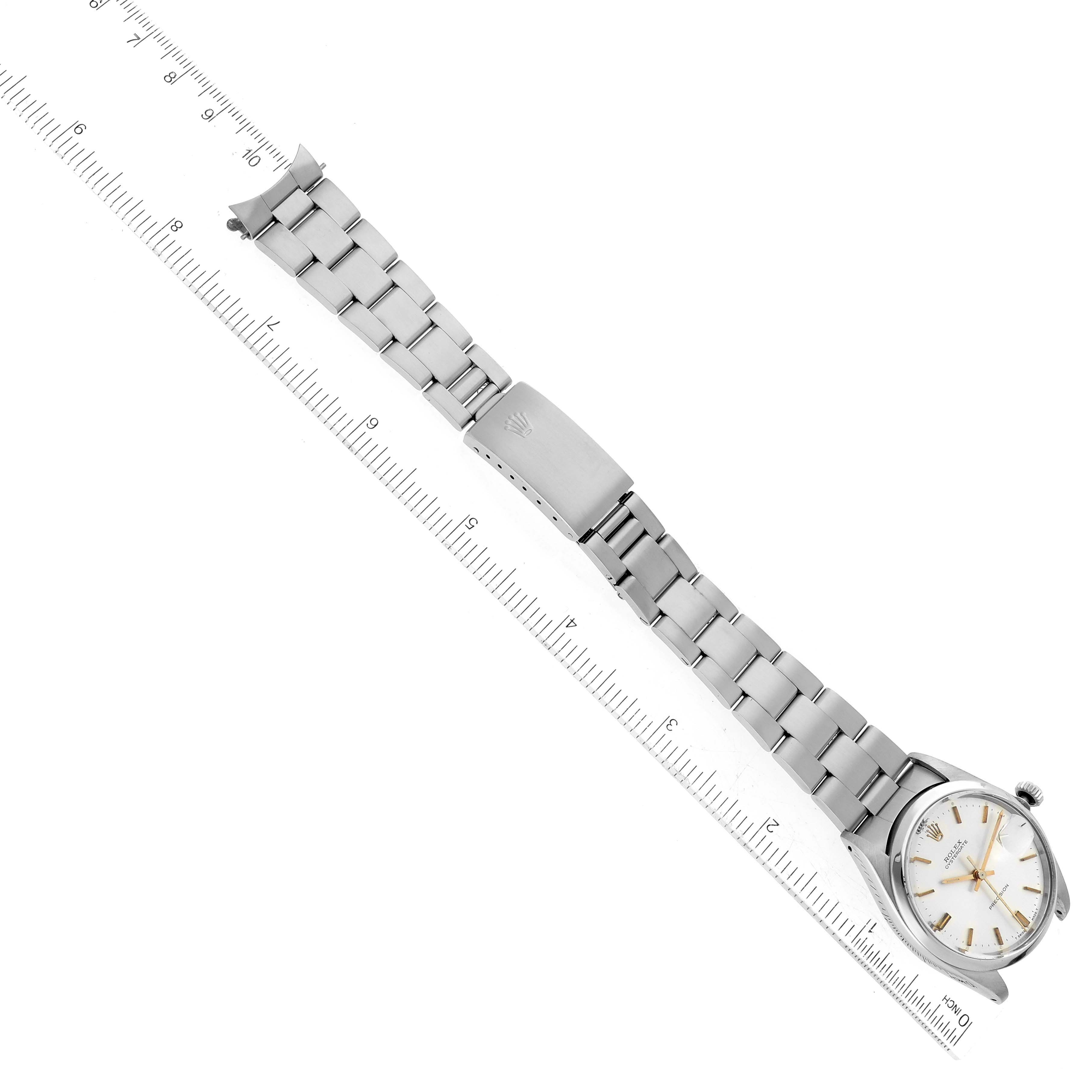 The Rolex Vintage Collection 6694 Men's Stainless Steel Silver Dial 6694 Men's Stainless Steel Silver Dial watch is shown in a flat, overhead view with the full band and clasp visible, alongside a ruler for scale.