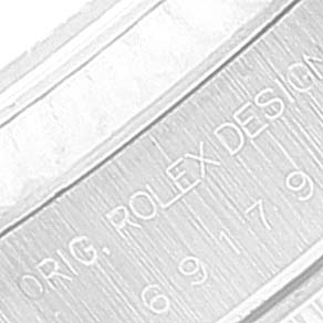 The image shows a close-up angle of the President model by Rolex, displaying the engraving on the inner bezel of the watch.