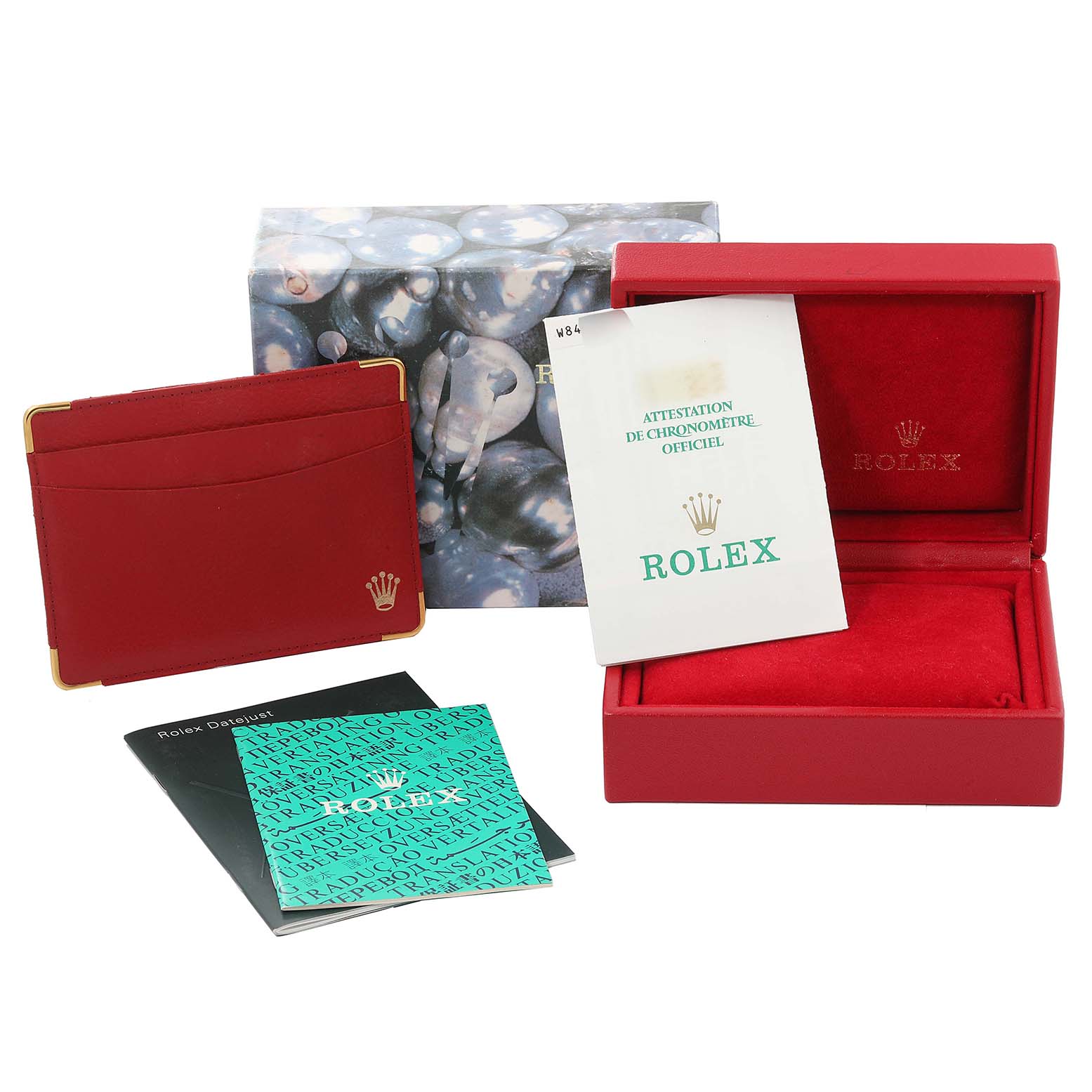 The image shows the accessories for a Rolex President 69179 Women's White Gold Silver Dial 69179 Women's White Gold Silver Dial model, including the box, manuals, red holder, and warranty card.