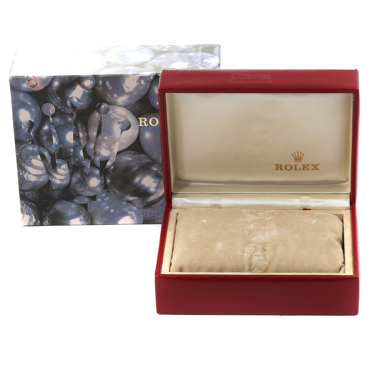 This image shows an open Rolex Datejust 69166 Women's Platinum Mother of Pearl Dial 69166 Women's Platinum Mother of Pearl Dial watch box with the lid open, placed in front of its outer decorative box.