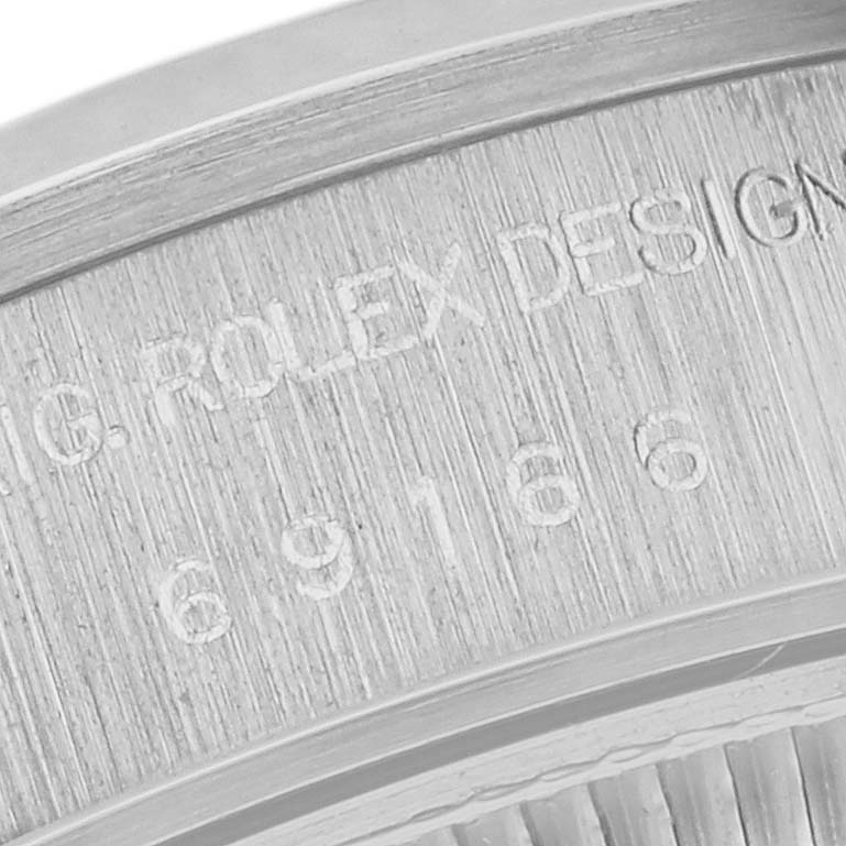 The image shows a close-up of the case back edge of a Rolex Datejust 69166 Women's Platinum Mother of Pearl Dial 69166 Women's Platinum Mother of Pearl Dial, highlighting the engraved model number and "ROLEX DESIGN" text.