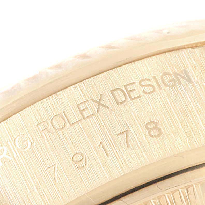 The image shows an engraved part of the case back of a Rolex President 79178 Women
s Yellow Gold Champagne Dial 79178 Women
s Yellow Gold Champagne Dial model watch, highlighting the "ROLEX DESIGN" inscription.