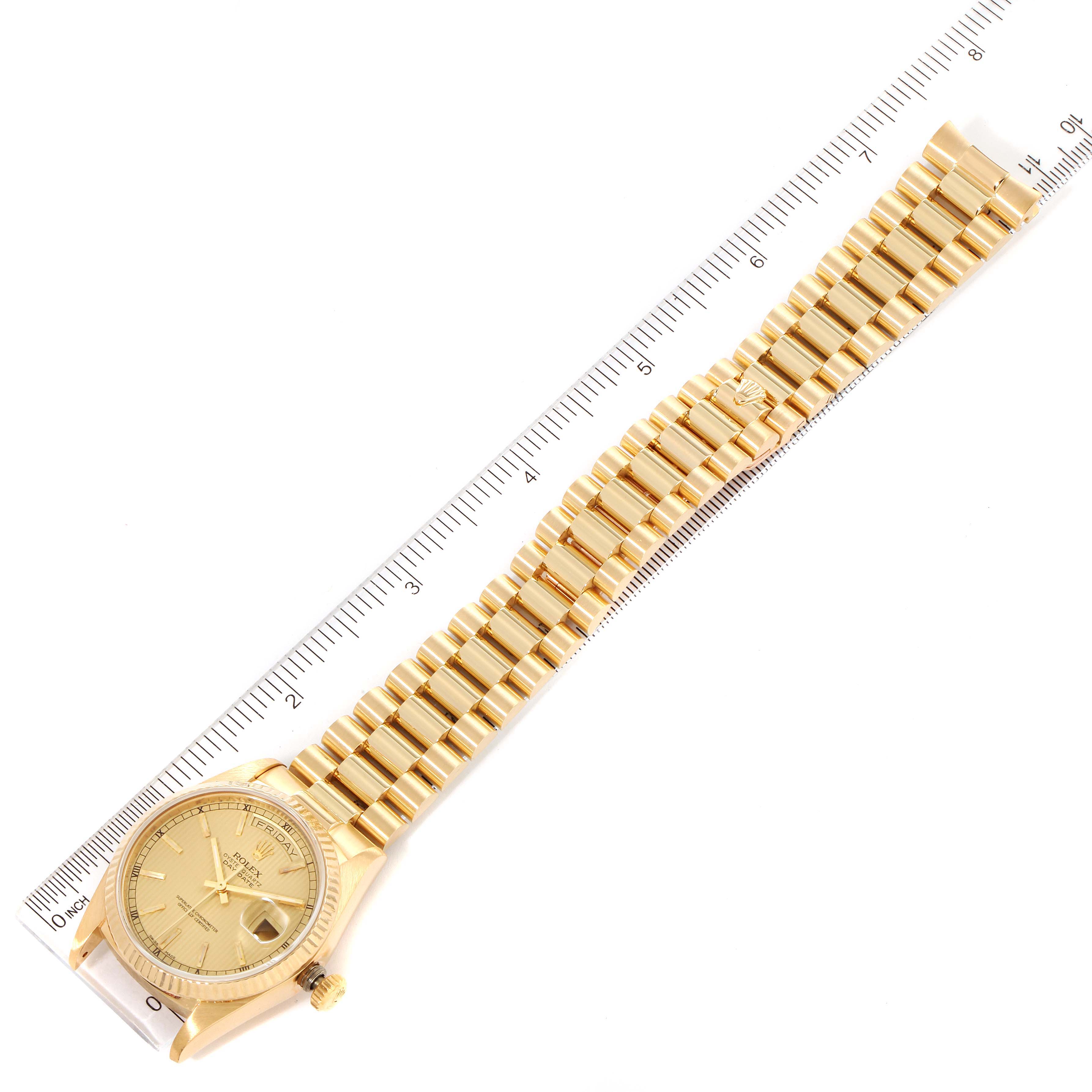 The image shows a Rolex President 18038 Men
s Yellow Gold Champagne Dial 18038 Men
s Yellow Gold Champagne Dial model watch laid flat with a ruler measuring its length, showcasing the watch face and bracelet.