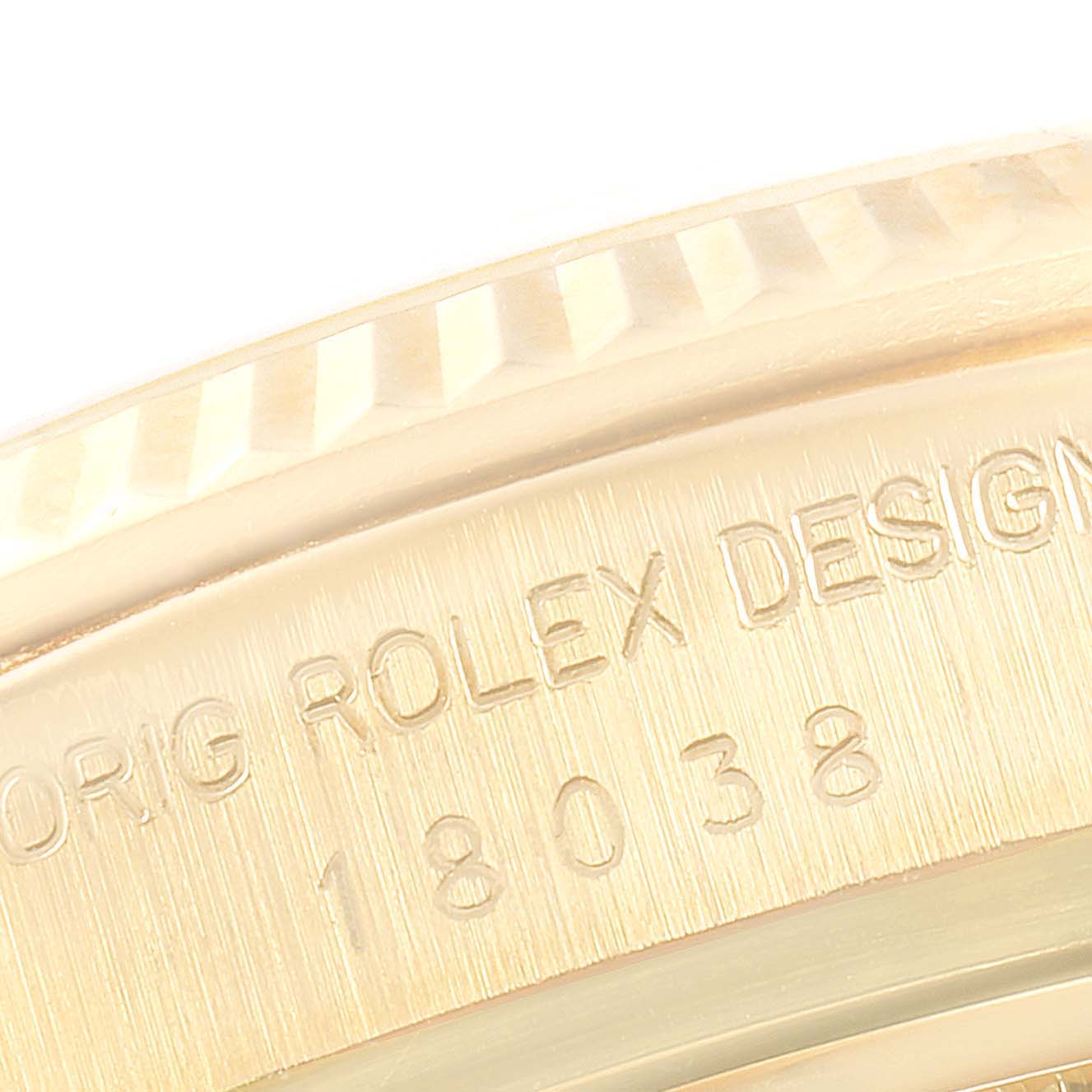 This close-up image shows the engraving and part of the bezel from a Rolex President 18038 Men
s Yellow Gold Champagne Dial 18038 Men
s Yellow Gold Champagne Dial model watch.