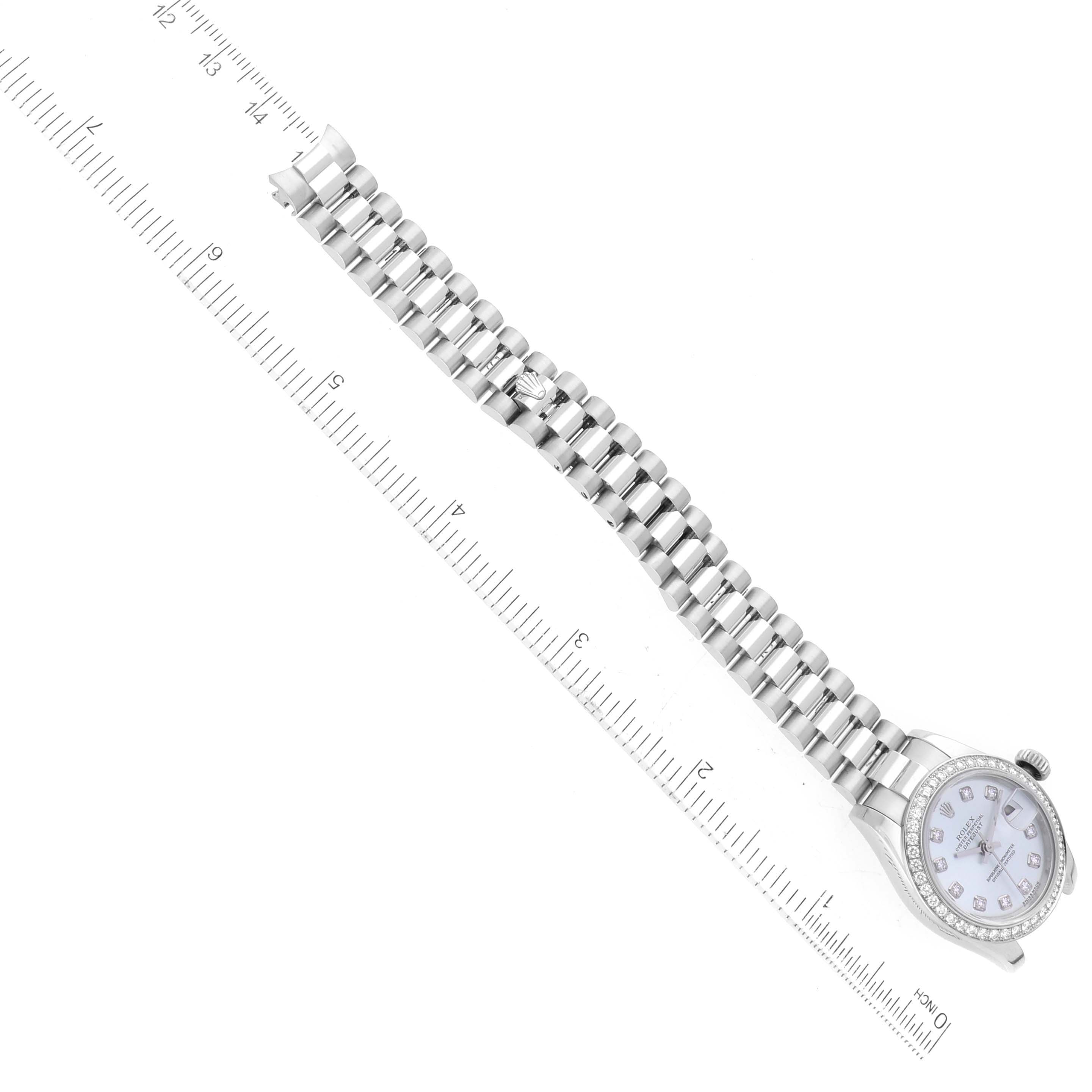 The image shows a top view of a Rolex President 179136 Women's Platinum Silver Dial 179136 Women's Platinum Silver Dial model watch, displaying the dial and the entire watch band alongside a measuring ruler.