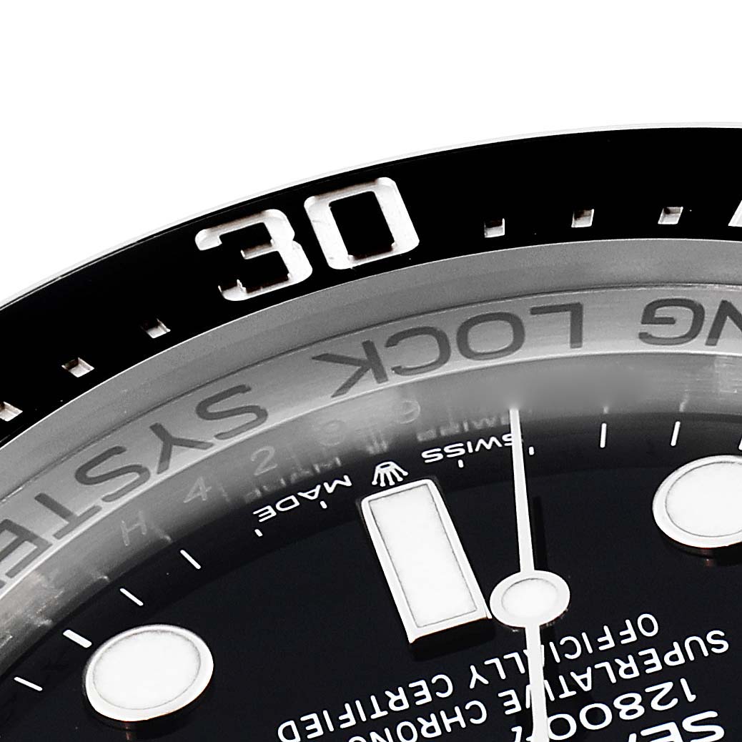 This close-up of the Rolex Sea-Dweller 126660 Men's Stainless Steel Blue Dial 126660 Men's Stainless Steel Blue Dial watch shows the upper part of the watch face, bezel, and part of the dial markers.