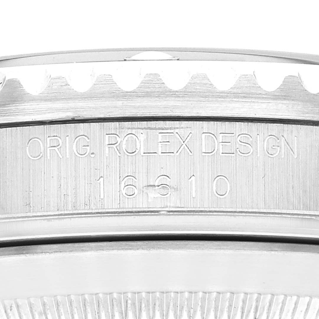 The image shows a close-up view of the engravings on the side of the bezel of a Rolex Submariner 16610 Men
s Stainless Steel Black Dial 16610 Men
s Stainless Steel Black Dial watch, highlighting its model number.