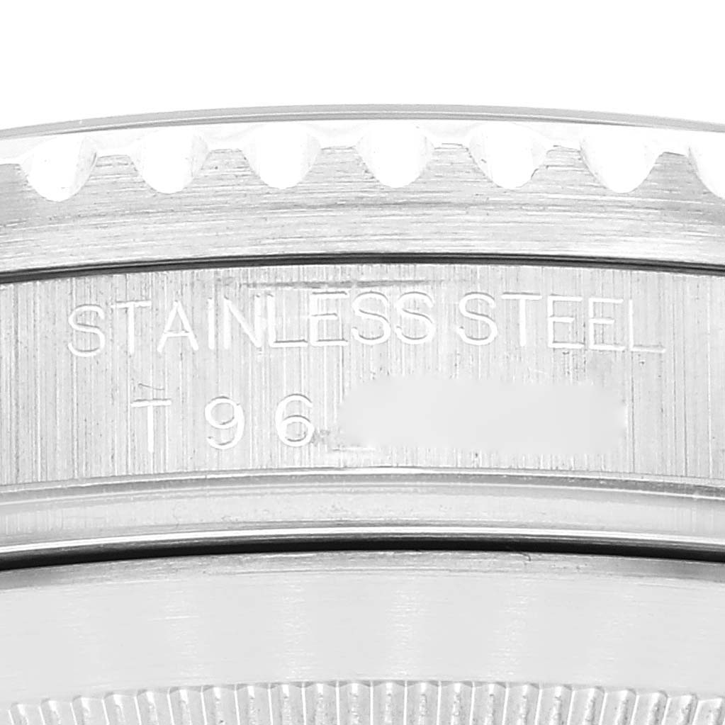 A close-up view of a Rolex Submariner 16610 Men
s Stainless Steel Black Dial 16610 Men
s Stainless Steel Black Dial watch case showing the "STAINLESS STEEL" engraving and part of the bezel.