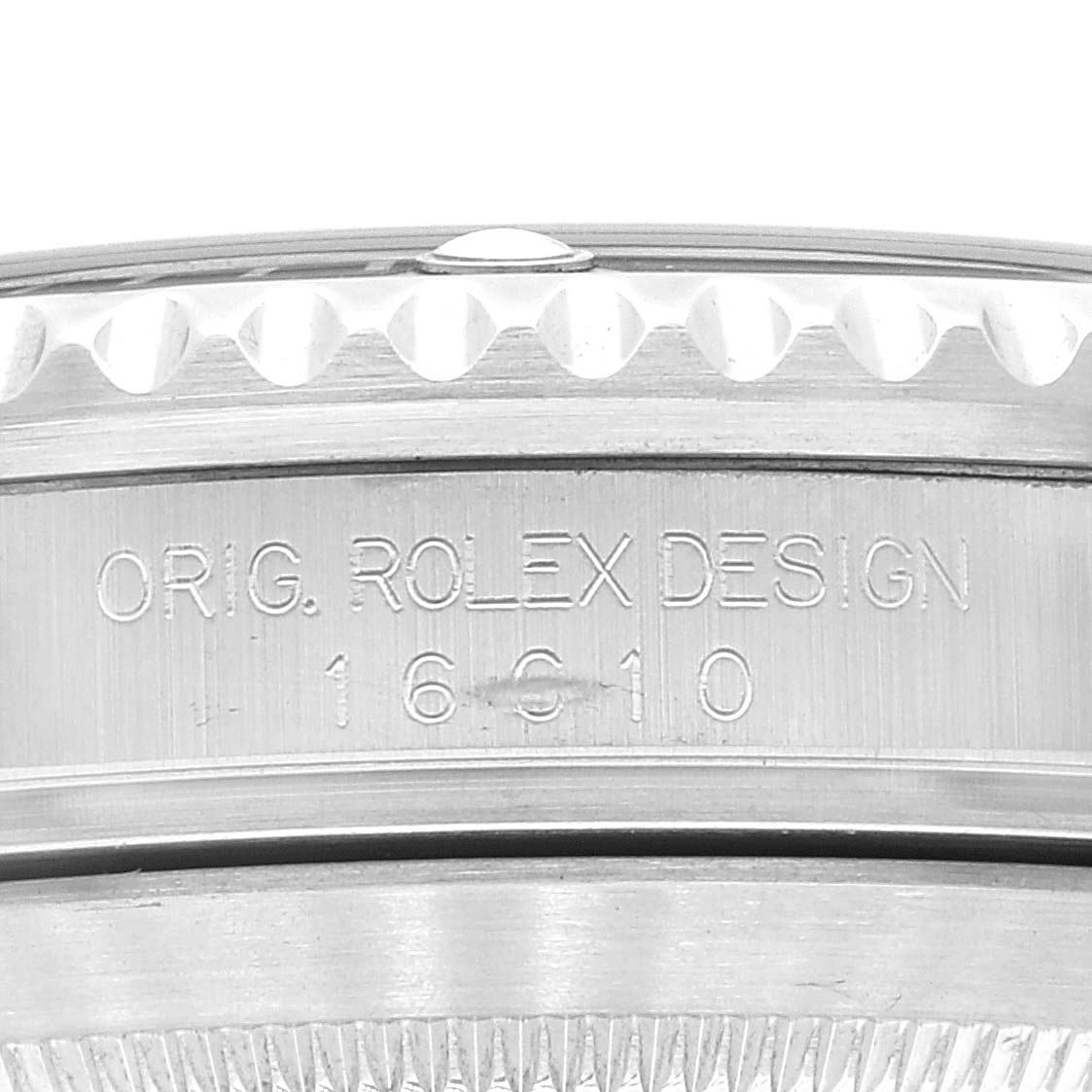 The image shows a close-up of the side engraving and bezel teeth of a Rolex Submariner 16610 Men
s Stainless Steel Black Dial 16610 Men
s Stainless Steel Black Dial watch.