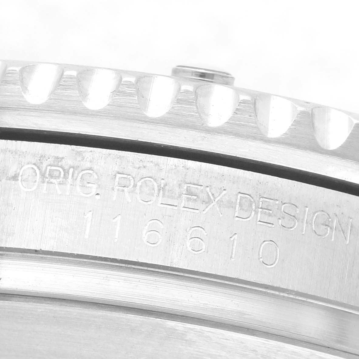 The image shows a close-up side view of the bezel and the engraved case of a Rolex Submariner 116610 Men's Stainless Steel Black Dial.