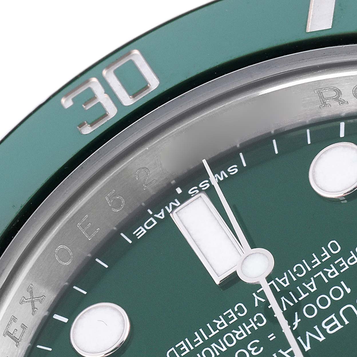 The image shows a close-up of the Rolex Submariner 116610LV Men's Stainless Steel Green Dial 116610LV Men's Stainless Steel Green Dial's green bezel, dial, and hands, focusing on the "30" marker and some text.