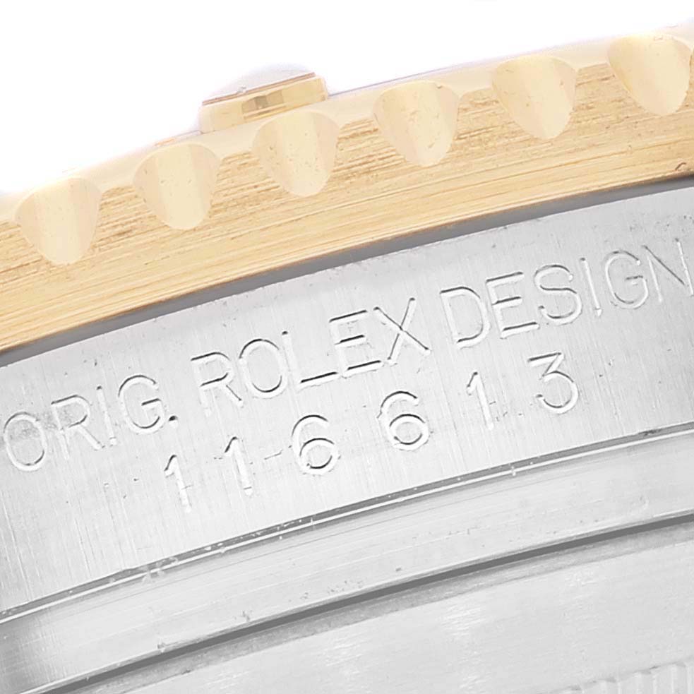 This close-up image shows the engraved details on the side of the bezel and case of a Rolex Submariner 116613 Men's Steel and Gold (two tone) Blue Dial 116613 Men's Steel and Gold (two tone) Blue Dial.