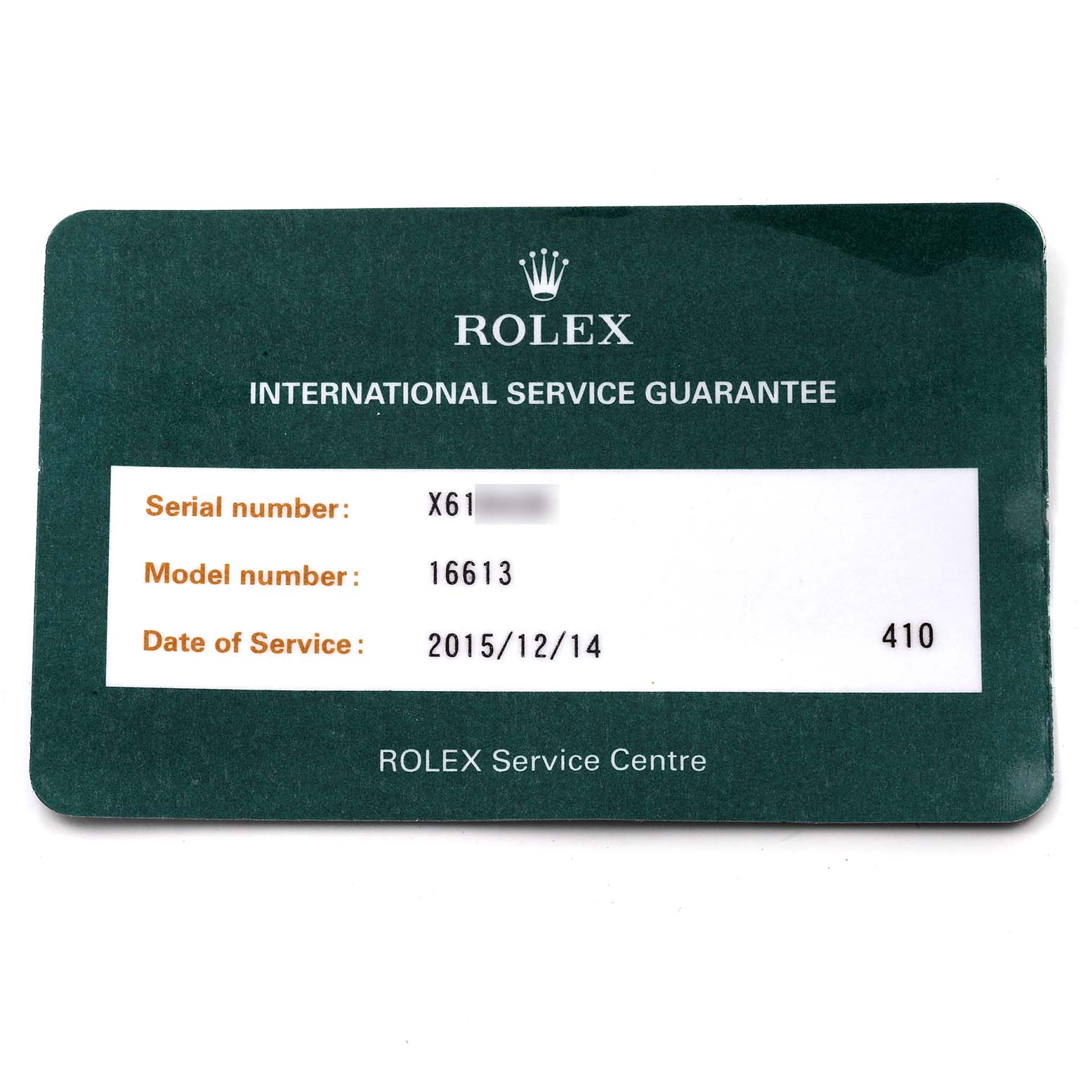 The image shows an International Service Guarantee card for a Rolex Submariner 16613 Men's Steel and Gold (two tone) Champagne Dial 16613 Men's Steel and Gold (two tone) Champagne Dial model 16613.